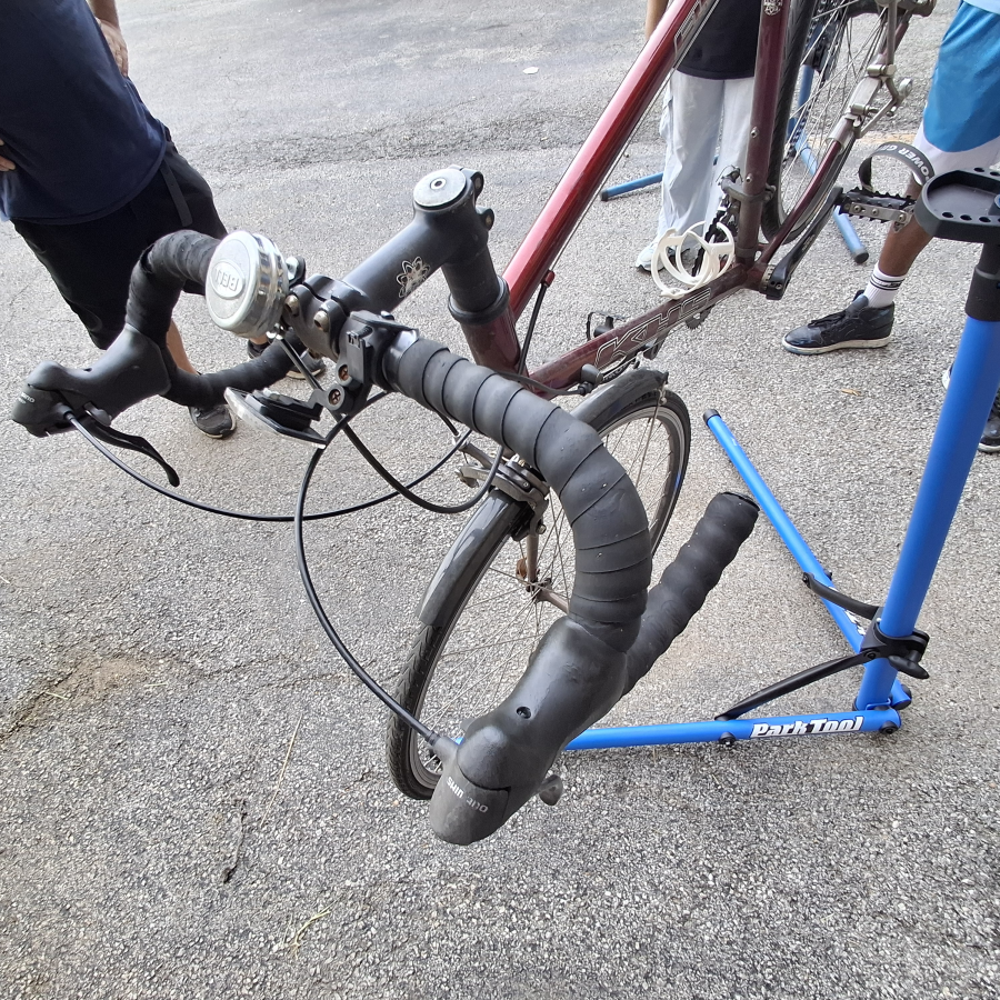 A bike in a repair stand, mid-adjustment